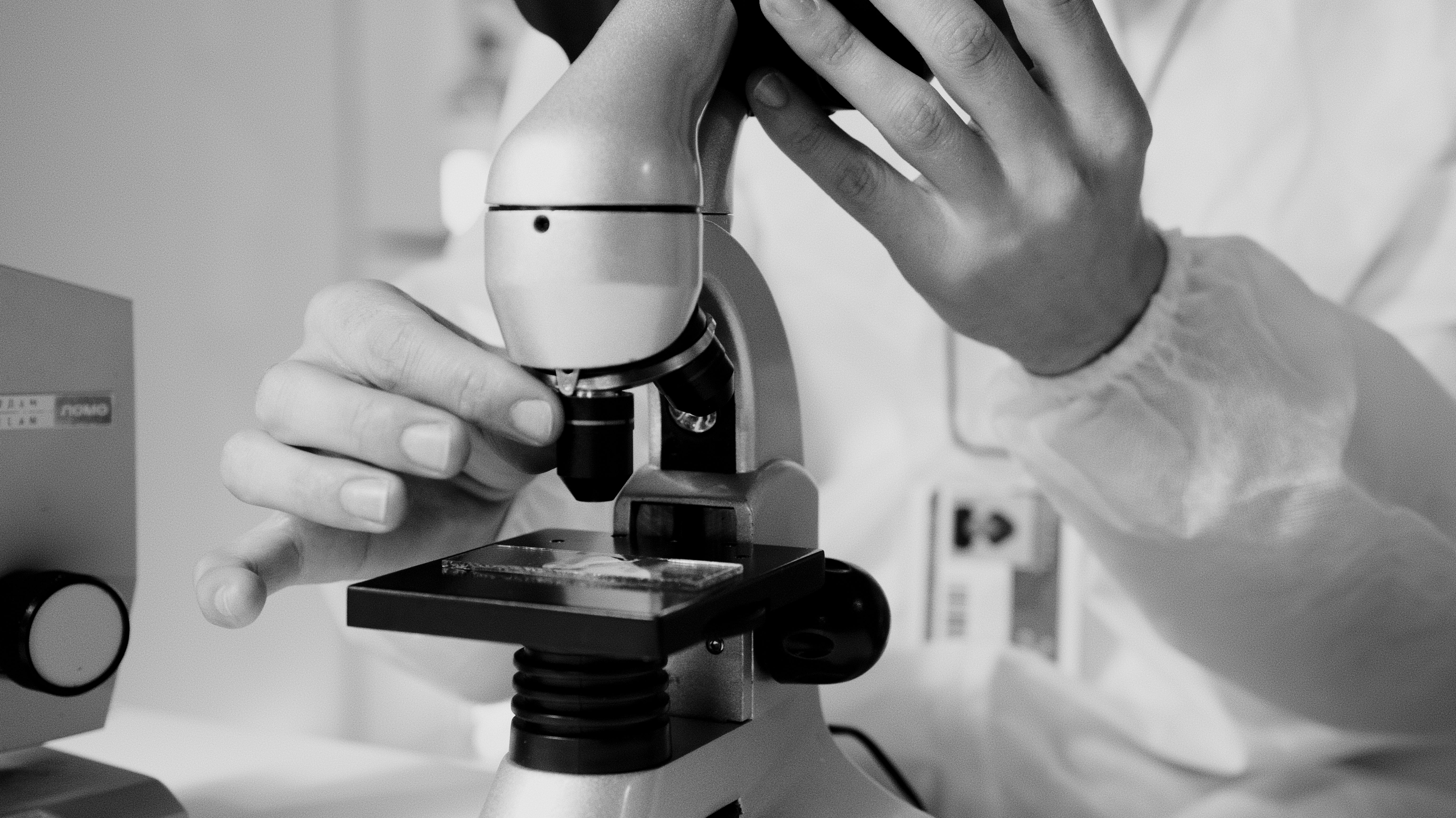 Researcher at a microscope